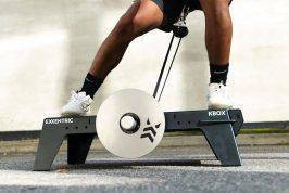 lateral squat on kBox Lite with M flywheel and platform extension foot block in an outdoor setting