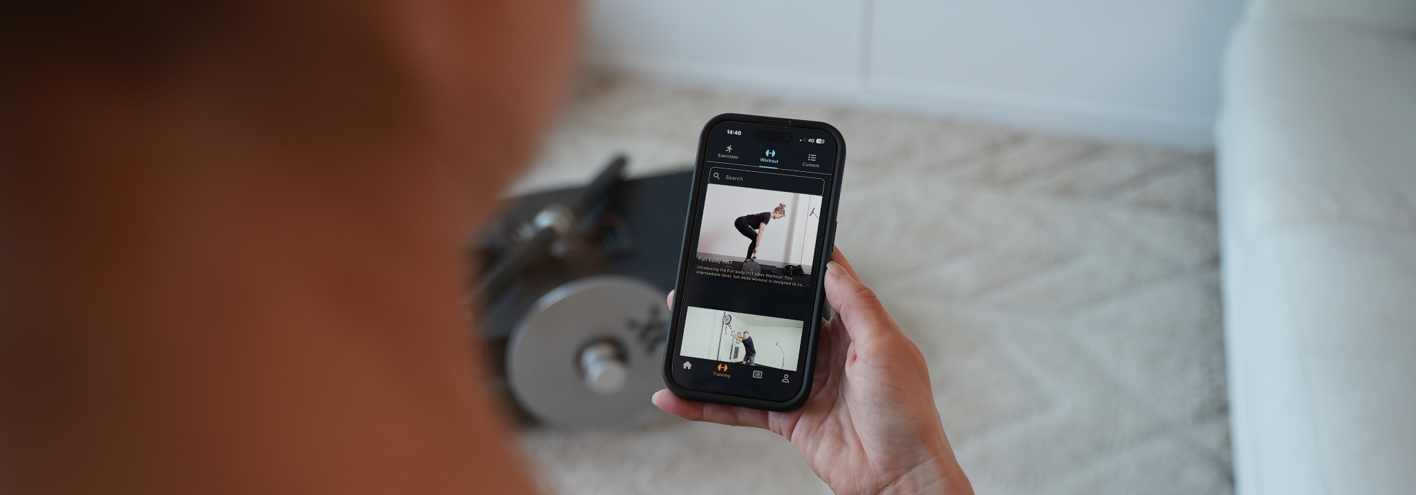 Person looking at a list of workouts in the Exxentric App