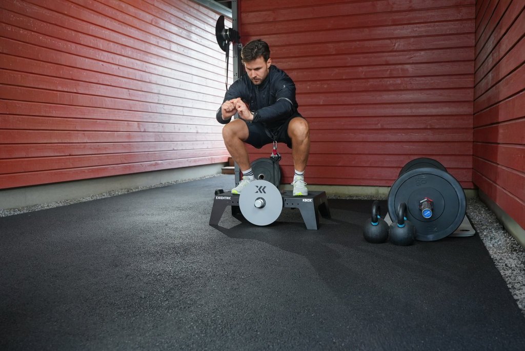 Squat on a kBox in a garage gym