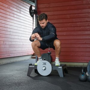 squat on a kBox in a garage gym