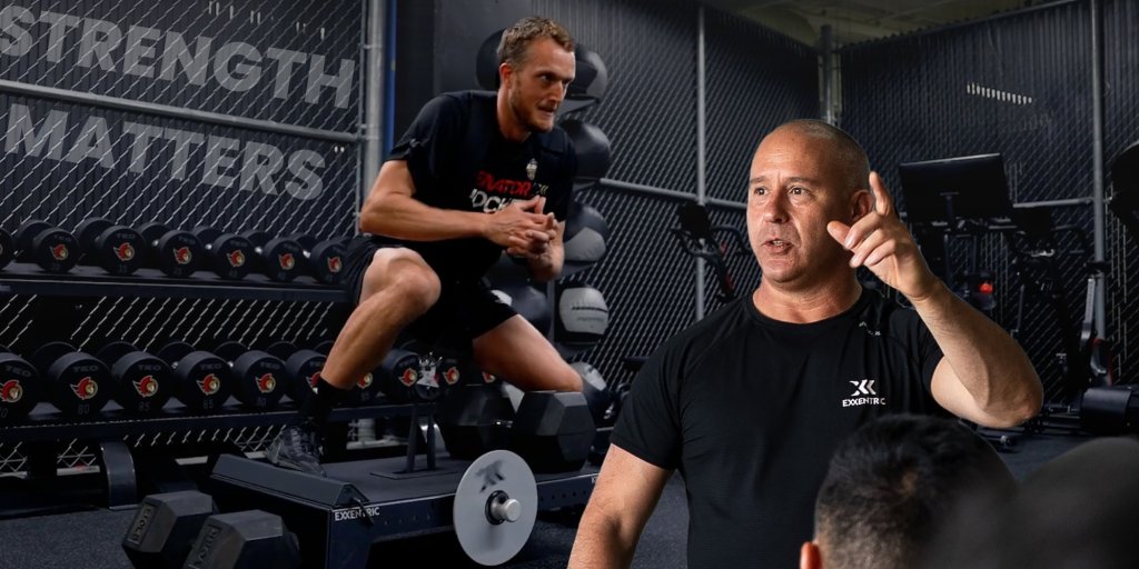 Fredrik leading a lecture with a lateral squat performed in the background